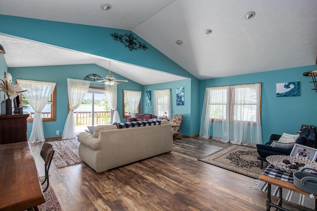 living room featuring vaulted ceiling, dark wood-type flooring, ceiling fan, and a textured ceiling