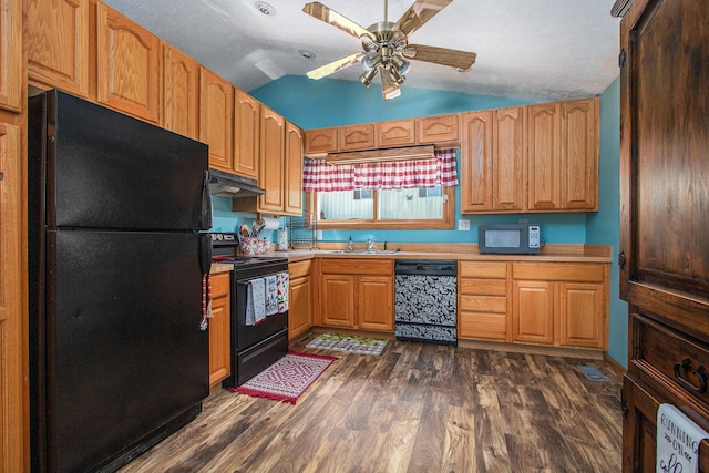 kitchen with dark wood-type flooring, sink, vaulted ceiling, a textured ceiling, and black appliances