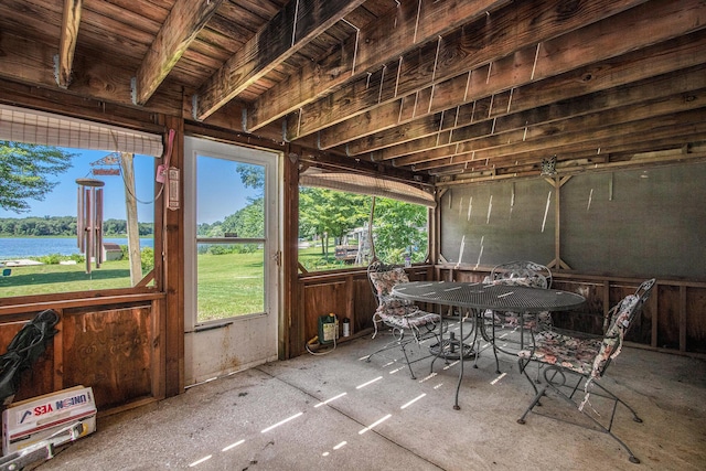 sunroom / solarium with a water view