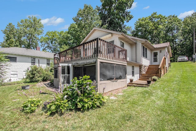 back of property with a yard and a sunroom