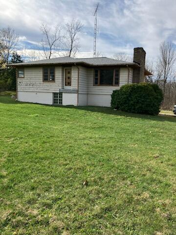 back of house with a lawn