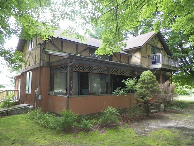 view of property exterior with a sunroom