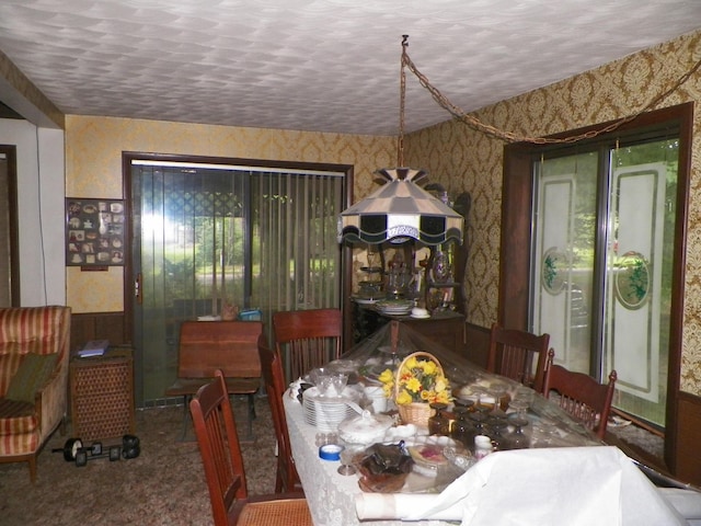 dining space featuring a textured ceiling and carpet flooring