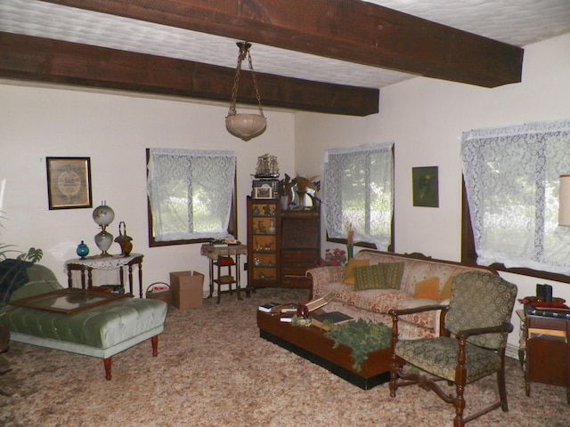 carpeted living room featuring beam ceiling