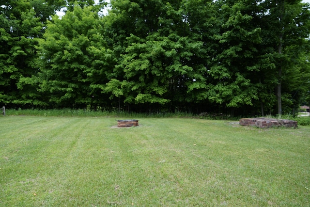 view of yard with a fire pit