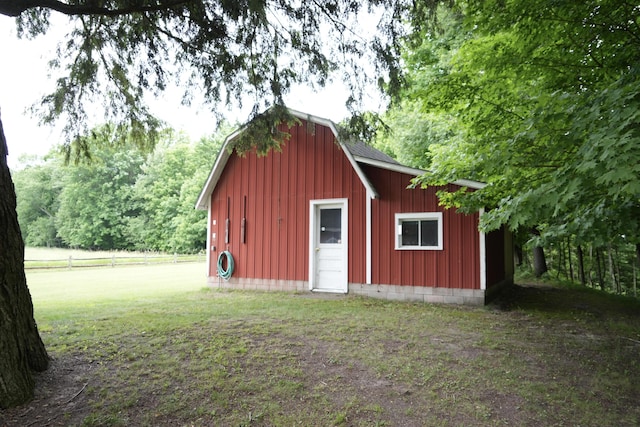 view of outbuilding featuring a lawn