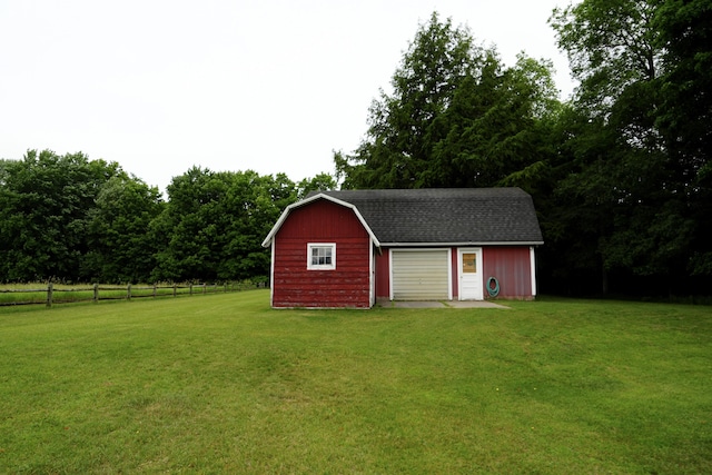 view of outbuilding with a garage and a lawn