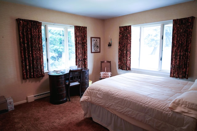 carpeted bedroom with multiple windows and a baseboard heating unit