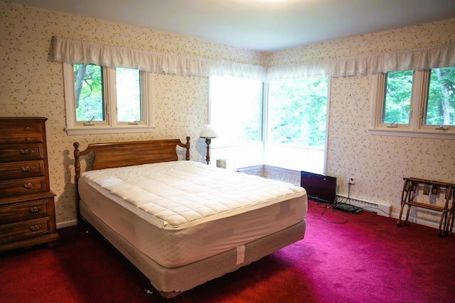 carpeted bedroom with a baseboard heating unit