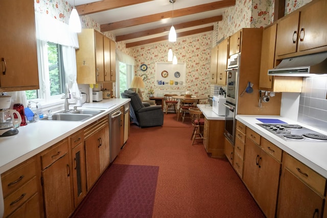 kitchen featuring sink, hanging light fixtures, stainless steel appliances, beam ceiling, and decorative backsplash