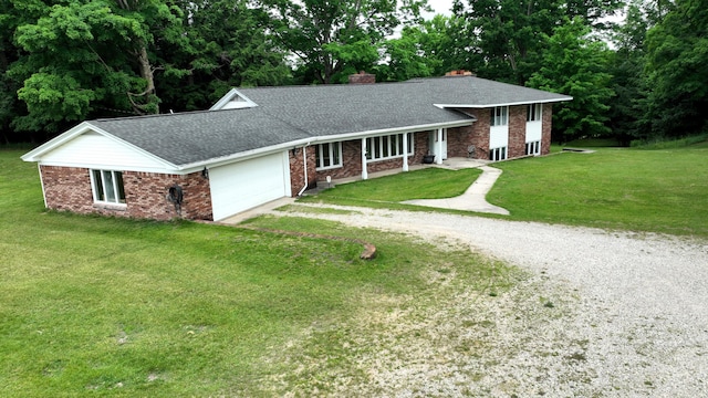 view of front of property with a garage and a front lawn