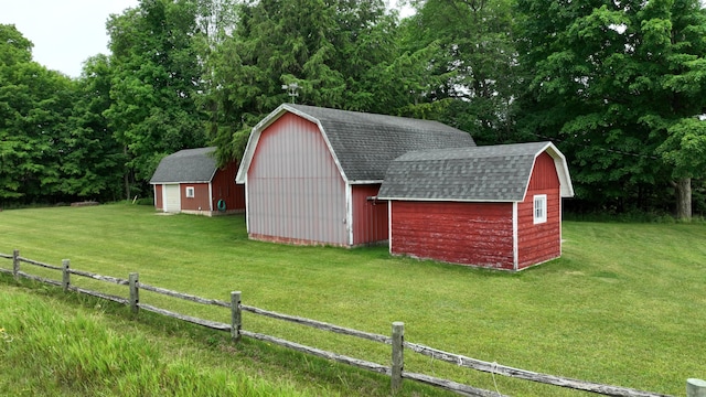 view of outbuilding featuring a lawn