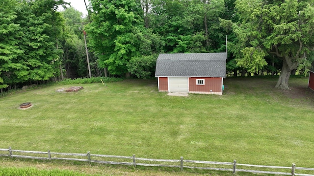 view of yard featuring a storage shed and an outdoor fire pit