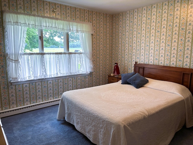 bedroom featuring carpet flooring, multiple windows, and a baseboard heating unit