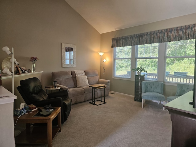 carpeted living room with lofted ceiling