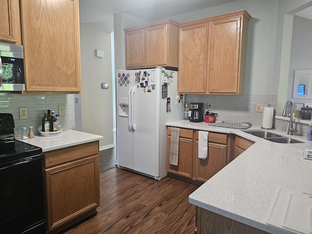 kitchen featuring tasteful backsplash, black range with electric cooktop, white fridge with ice dispenser, and sink