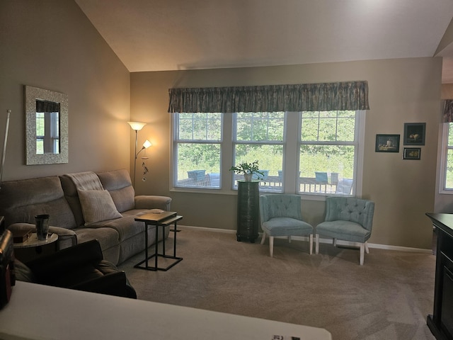 living room featuring lofted ceiling and carpet flooring