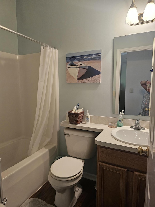 full bathroom featuring shower / bathtub combination with curtain, vanity, and toilet