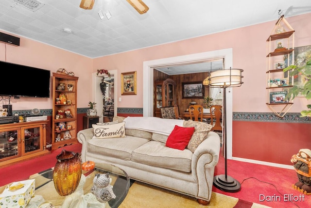 living area featuring visible vents and a ceiling fan