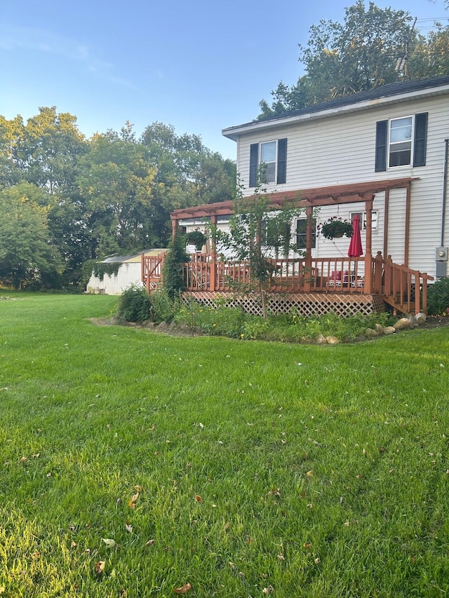 back of property featuring a yard and a wooden deck