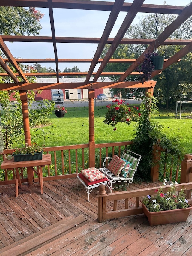 wooden deck featuring a lawn and a pergola