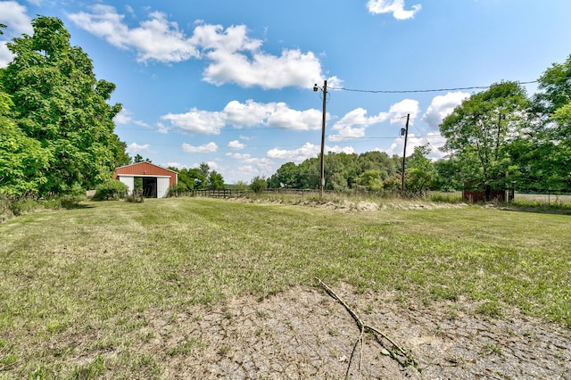 view of yard featuring an outbuilding and a rural view