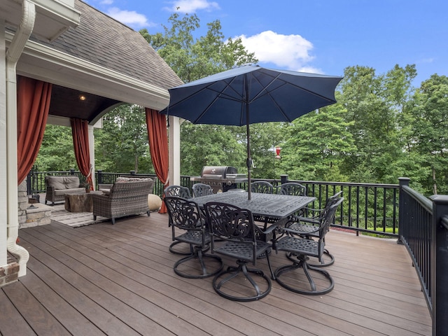 deck featuring outdoor dining space, grilling area, and an outdoor hangout area