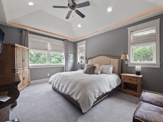 bedroom featuring light carpet, multiple windows, baseboards, and vaulted ceiling