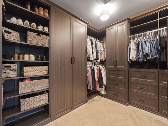 spacious closet with stone finish floor