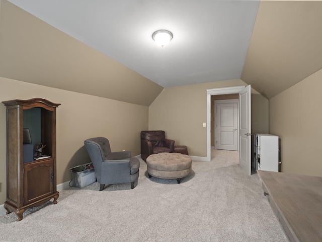 living area featuring lofted ceiling, carpet, and baseboards