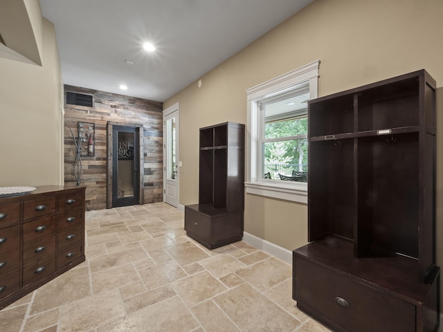 mudroom with visible vents, baseboards, recessed lighting, a fireplace, and stone tile flooring