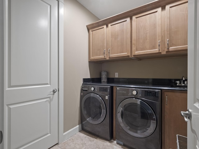 laundry area with visible vents, baseboards, separate washer and dryer, cabinet space, and a sink