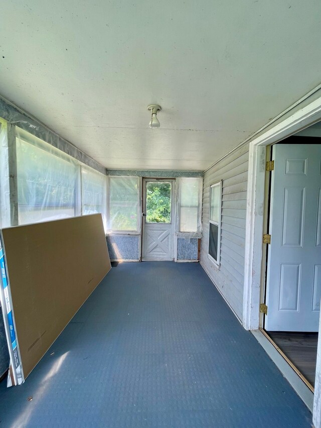 unfurnished sunroom with a fireplace