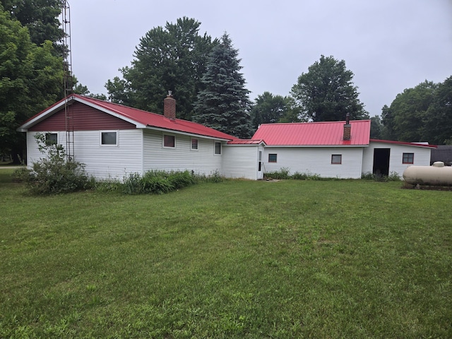 back of house with a lawn