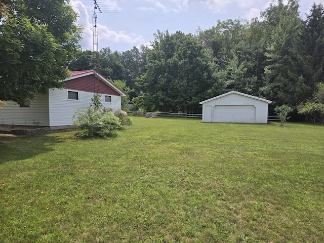 view of yard with a garage and an outdoor structure