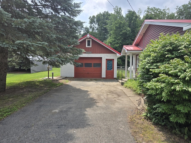 exterior space featuring a yard, a garage, and an outdoor structure