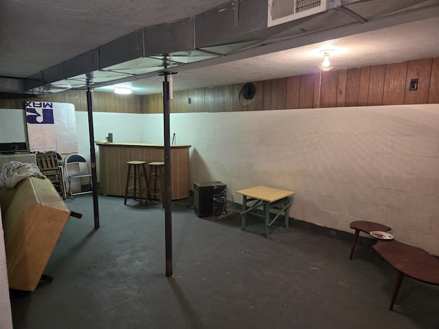 basement with indoor bar