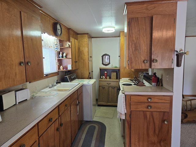 kitchen featuring washer / clothes dryer and sink