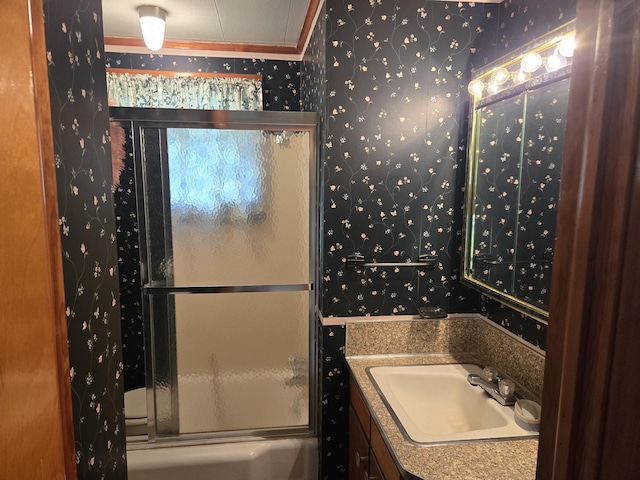 bathroom with vanity and enclosed tub / shower combo