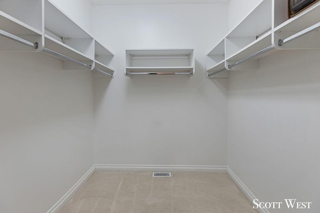 walk in closet with light carpet and visible vents