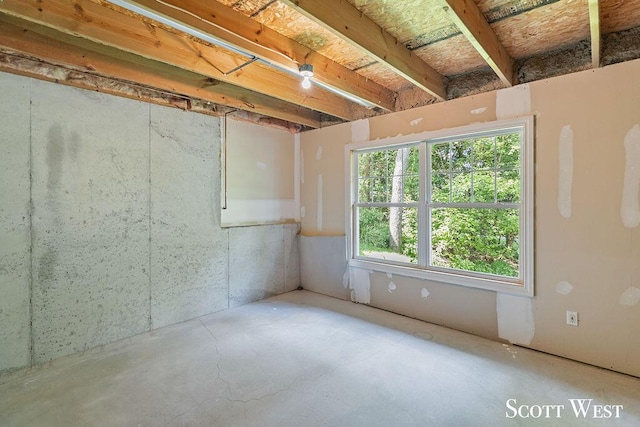 unfurnished room with concrete flooring