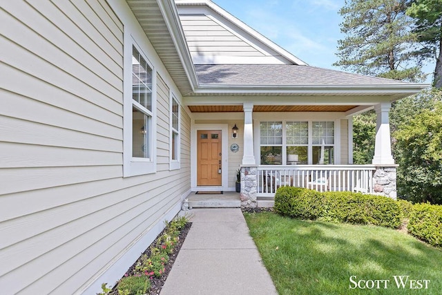 doorway to property with a shingled roof and covered porch