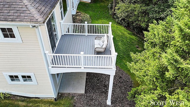 exterior details with gutters, roof with shingles, and a downspout