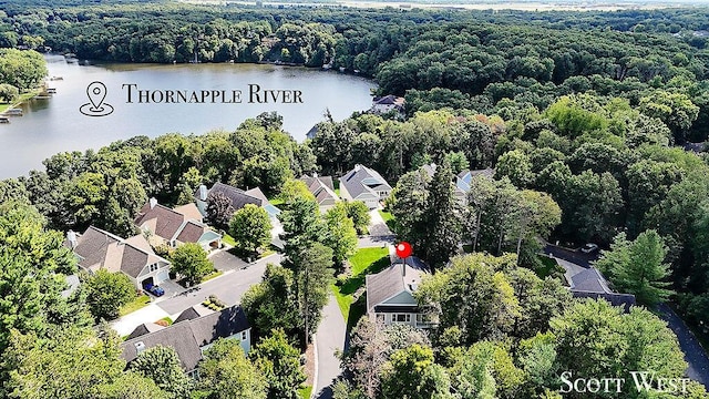 birds eye view of property featuring a water view, a residential view, and a view of trees