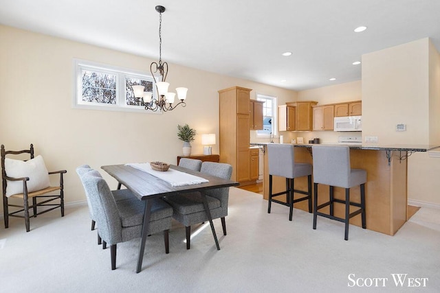 dining room with sink and an inviting chandelier