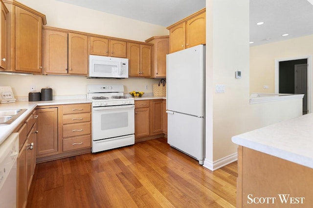 kitchen featuring light hardwood / wood-style floors, white appliances, and sink