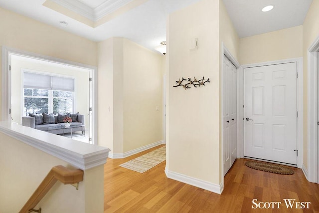 corridor featuring wood-type flooring and ornamental molding