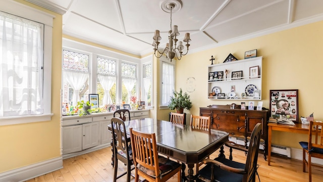 dining space with baseboard heating, light wood-type flooring, crown molding, and a chandelier