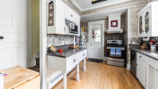 kitchen featuring white cabinetry, crown molding, stainless steel appliances, and light wood-type flooring