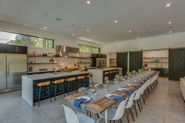 15963 Lakeshore Rd, Union Pier, MI 49129 - dining space with concrete flooring, recessed lighting, and a barn door